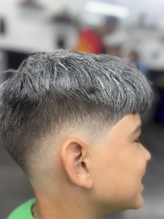 Textured crop with mid fade by barber Dayan at Yovany Barbershop #3, North Fort Myers FL